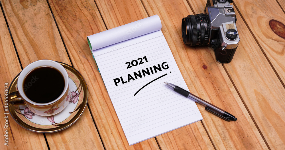 Handwritting quote 2021 Planning on white paper at top wood table Handwritting quote 2021 Planning on white paper at top wood table