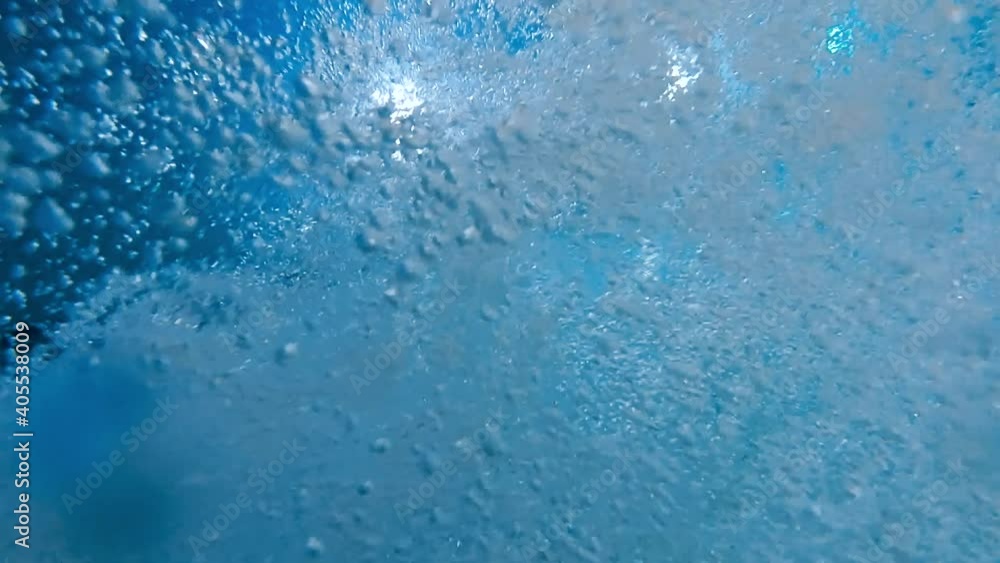 Abstract slow motion background of lots of air bubbles in clear blue water. Beautiful under water background or backdrop. Abstract slow motion background of lots of air bubbles in clear blue water. Beautiful under water background or backdrop.