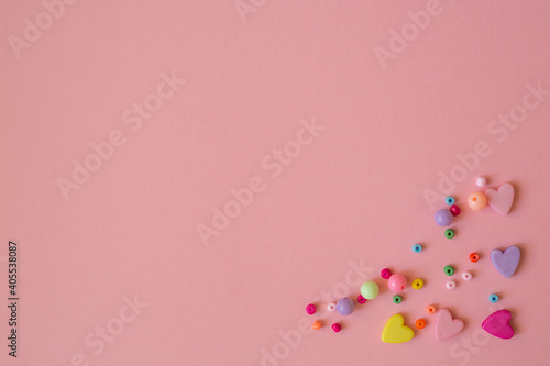 Template with place for text. Happy valentines day pink card with multicolored hearts. Multi-colored beads to create jewelry and bijouterie