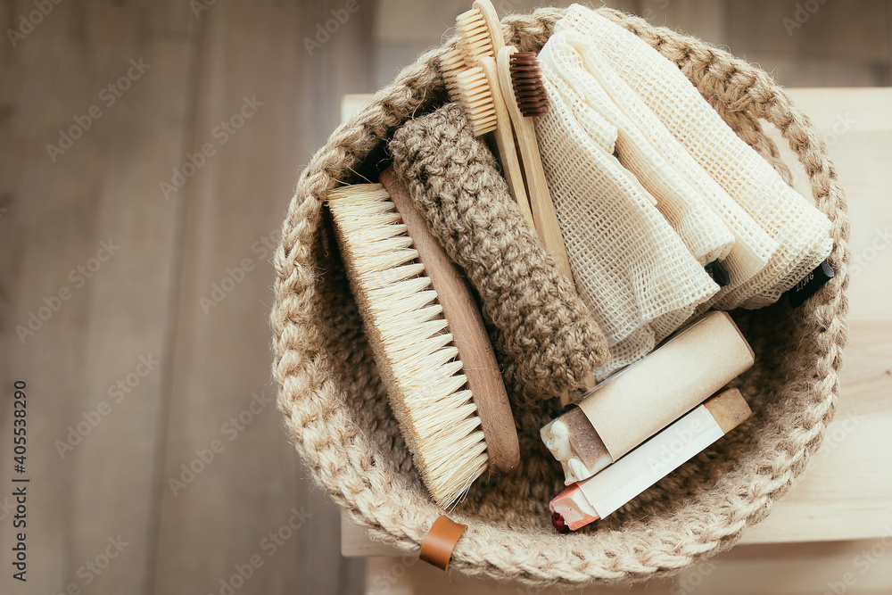 Fototapeta premium Natural product in jude basket. Bodybrush, toothbrush, shopping bag, soap. Treat yourself concept