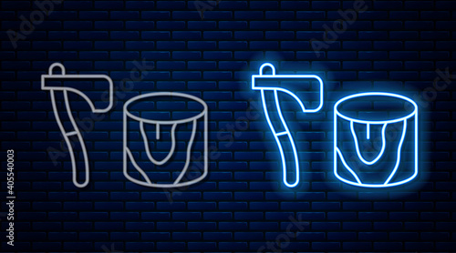 Glowing neon line Wooden axe in stump icon isolated on brick wall background. Lumberjack axe. Axe stuck in wood. Chopping wood. Vector.