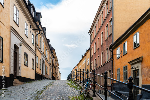 Picturesque cobblestoned street with colorful houses in Ugglan quarter in Sodermalm in Stockholm