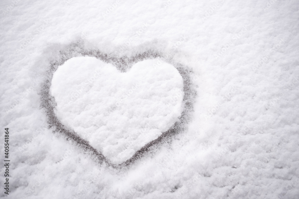 Heart shaped drawing on white snow Heart shaped drawing on white snow