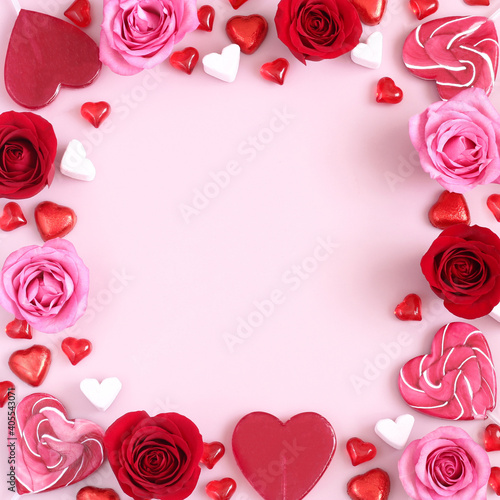 Valentine s Day background of pink and red roses and heart shaped candies. Mothers Day  birthday  Valentines Day  Womens Day  love concept. Space for text.