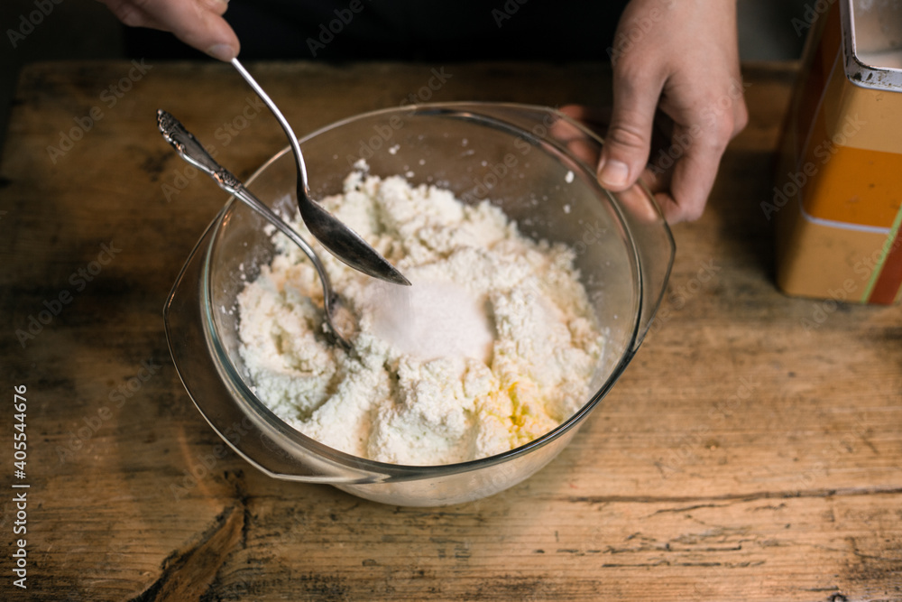 Adding sugar to curd with a spoon Adding sugar to curd with a spoon