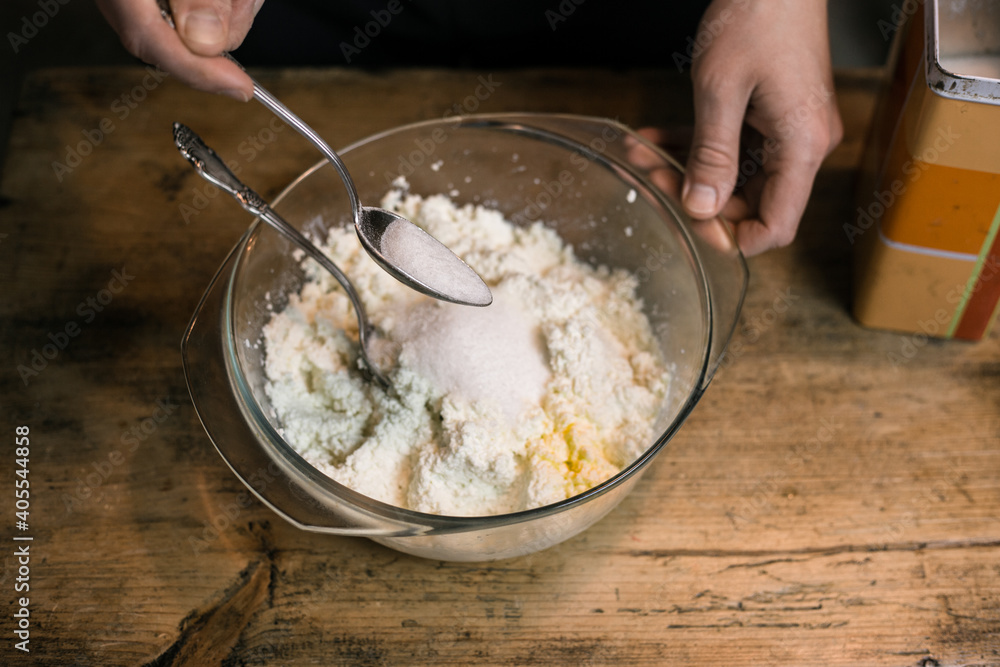 Adding sugar to curd with a spoon Adding sugar to curd with a spoon