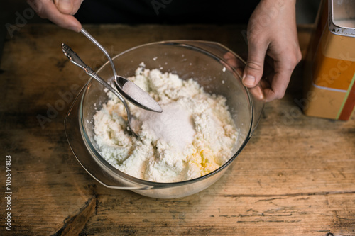 Adding sugar to curd with a spoon