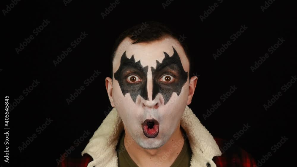 Man in demon makeup screaming in rage on black background Man in demon makeup screaming in rage on black background