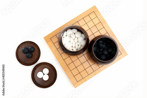 Go game stones in wooden bowls photo