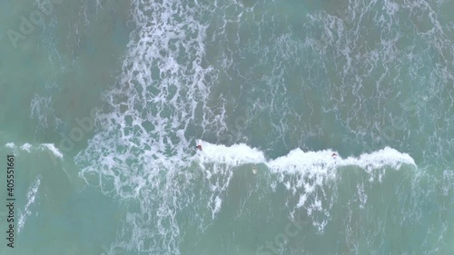 Wallpaper Mural Aerial top down view of surfers catching waves and falling down in the intent to ride it Torontodigital.ca