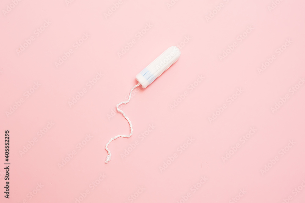Clean white cotton tampons on pink background. Menstruation. Feminine Hygiene in periods, beauty treatment. Clean white cotton tampons on pink background. Menstruation. Feminine Hygiene in periods, beauty treatment.