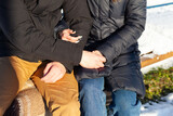 Young man and girl hold hands in winter