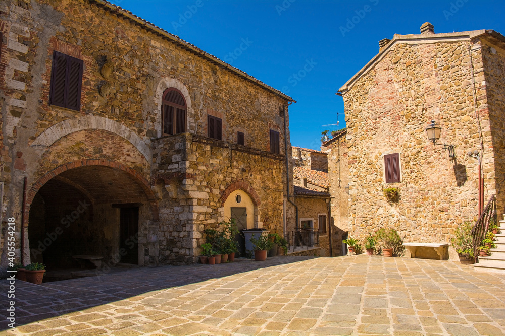 Historic stone residential buildings in the village of Montemerano near Manciano in Grosseto province, Tuscany, Italy
