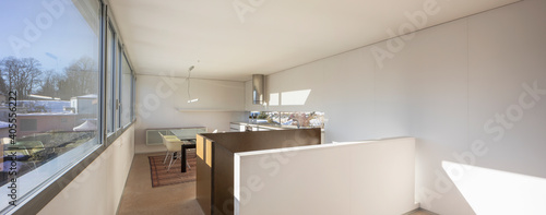 Panoramic interior of dining room and kitchen