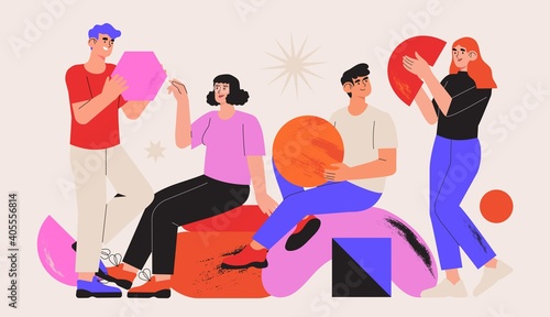People organize abstract geometric shapes scattered around them. Young men and women collecting figures and organise them. Concept of teamwork. Team or colleagues work together on creative project.
