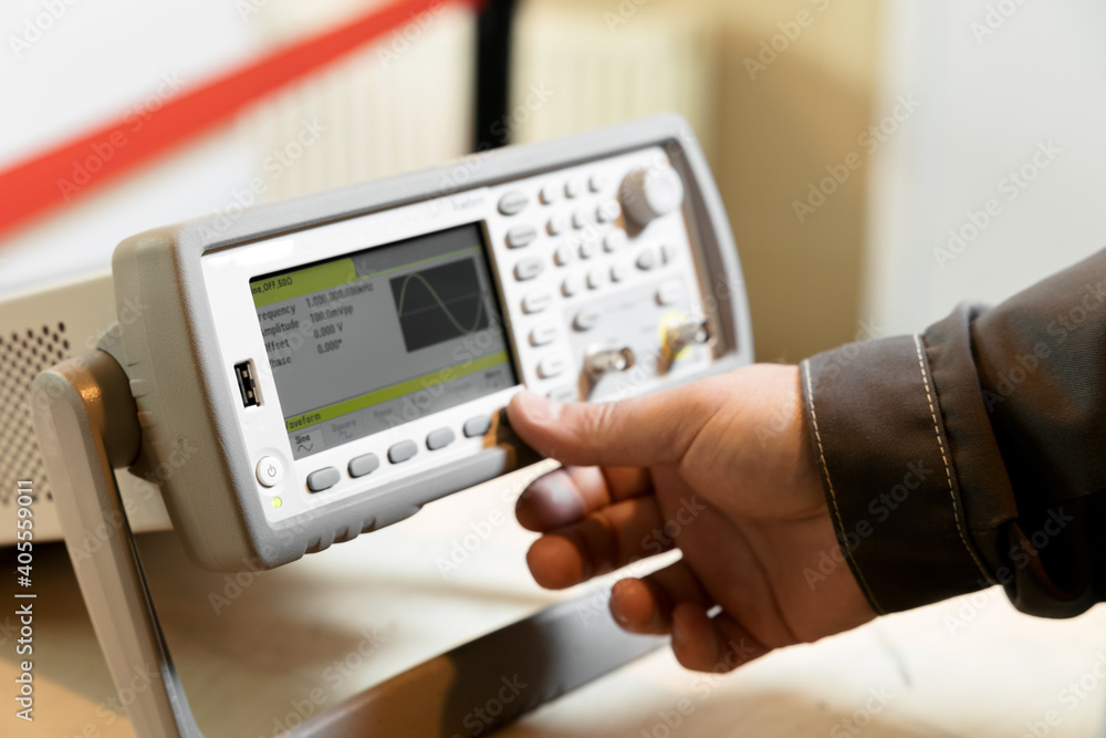 Engineer hand use Electrical equipment for measure in circuit. Modern digital measuring instruments. Multimeter equipment. Abstract industrial background. Waveform generator Engineer hand use Electrical equipment for measure in circuit. Modern digital measuring instruments. Multimeter equipment. Abstract industrial background. Waveform generator