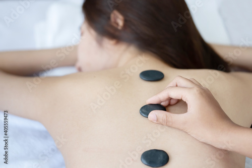 Asian Woman Having a Hot Stone Massage Treatment
