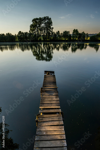 old wooden pier at lake in evening time