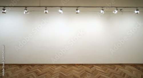 Interior of a empty white wall with spot lights at art gallery