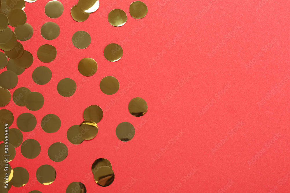 Shiny golden confetti on red background, flat lay. Space for text Shiny golden confetti on red background, flat lay. Space for text