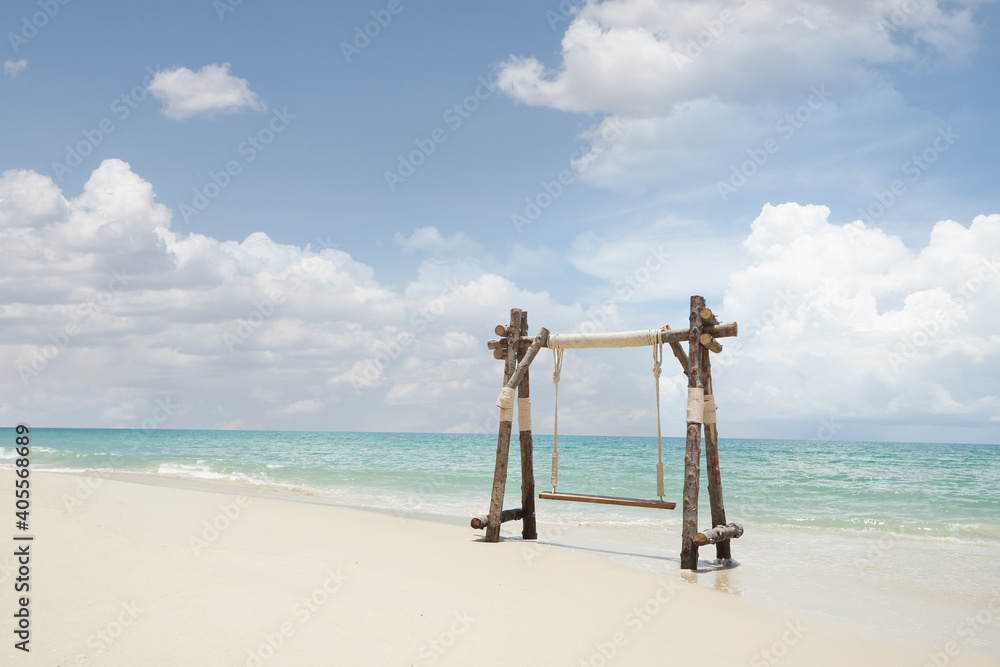 View of nice wooden swing on summer tropic beach View of nice wooden swing on summer tropic beach