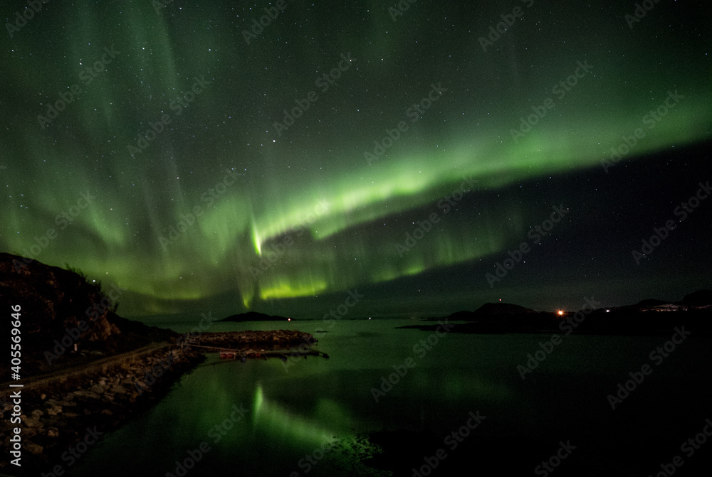 Reflections of aurora over water