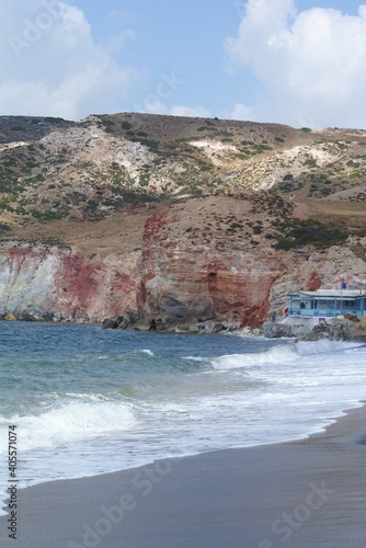 Red rock cliffs at Paliochori Beach in Milos, Greece photo