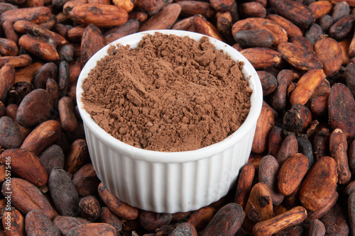 Powdered cocoa on raw cocoa beans