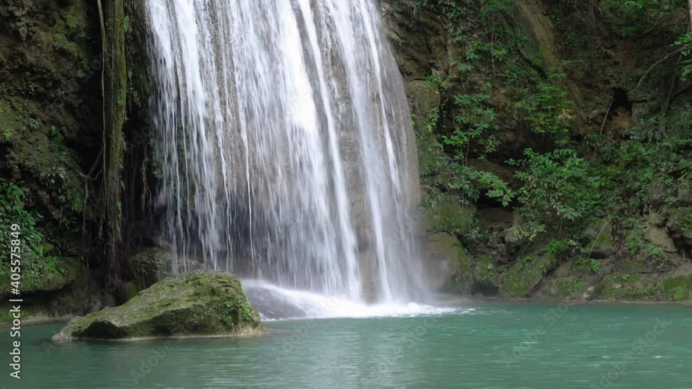 Powerful waterfall plunge from cliff into pond or lake Powerful waterfall plunge from cliff into pond or lake