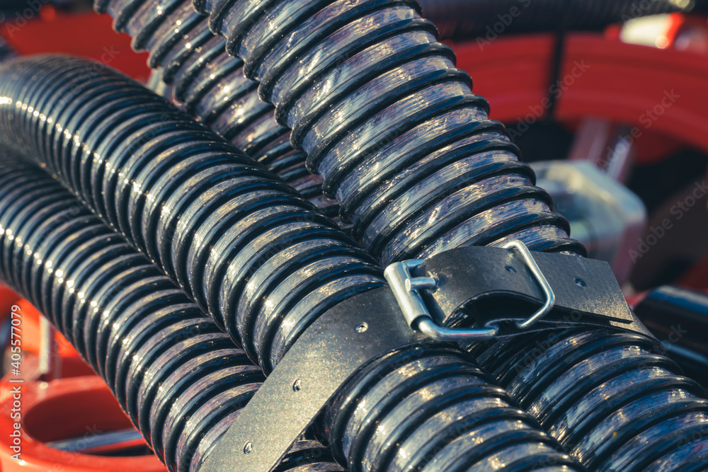 Close-up of a bundle of corrugated fertilizer pipes for an agricultural seeder. Close-up of a bundle of corrugated fertilizer pipes for an agricultural seeder.