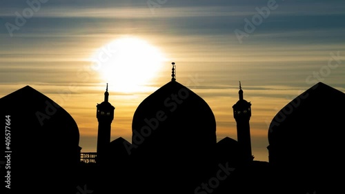 Dome and Minarets of Hazrat-e Masumeh Shrine in Holy City of Qom, Iran, Time Lapse at Sunset photo
