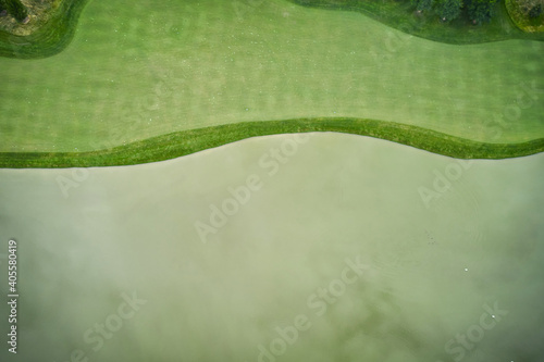 Green grass and lake. Curved coastline