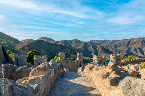 Medieval fortress facing the mountains with defense and surveillance towers located in the Mediterranean region of Murcia and within the so-called route of the castillitos photo