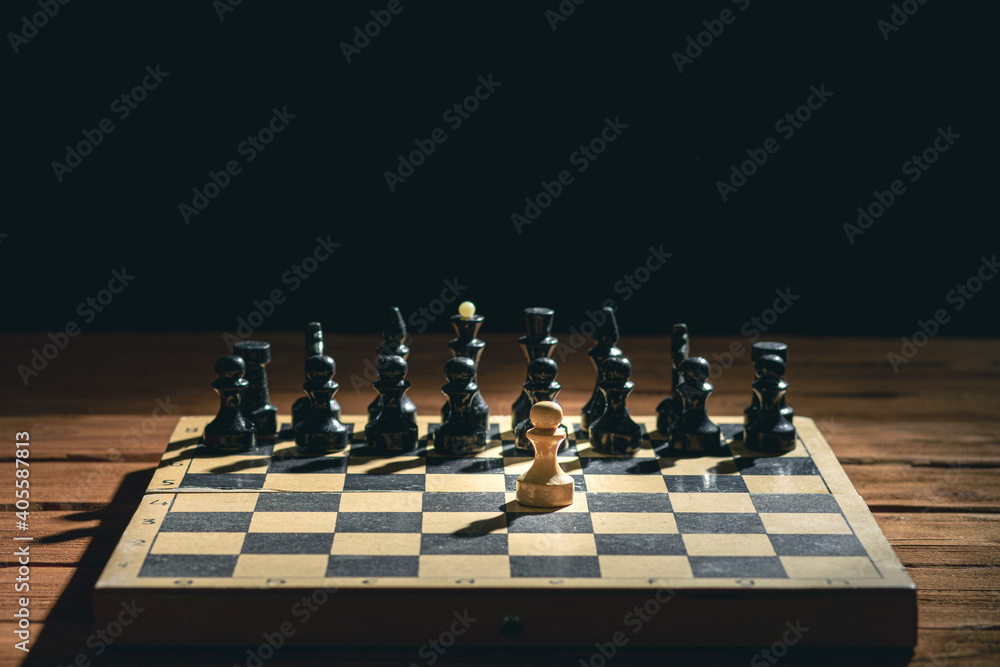 Wooden chess pieces on a chessboard on a black background. Mockup. Blank space for text Wooden chess pieces on a chessboard on a black background. Mockup. Blank space for text