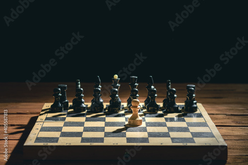 Wooden chess pieces on a chessboard on a black background. Mockup. Blank space for text