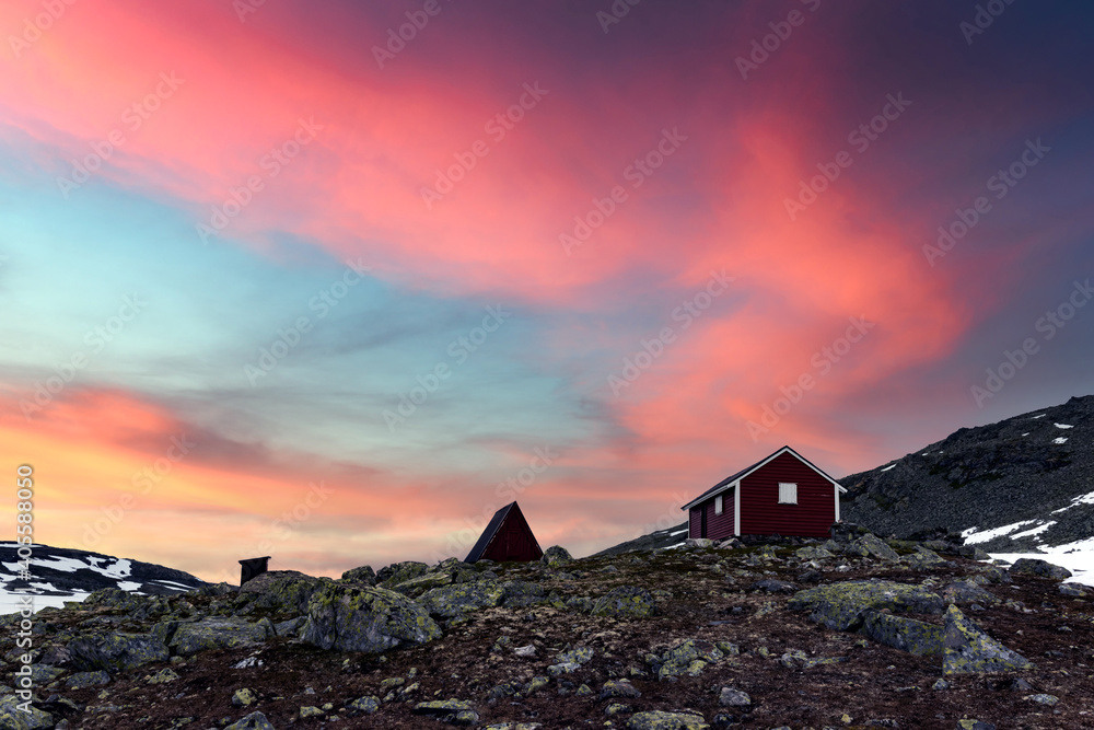 Typical norwegian red wooden house near famous Aurlandsvegen (Bjorgavegen) mountain road in Aurland, Norway in sunset time. Landscape photography