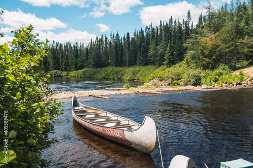 Canvastavla Canoe floating on Lake in a forest of Canada