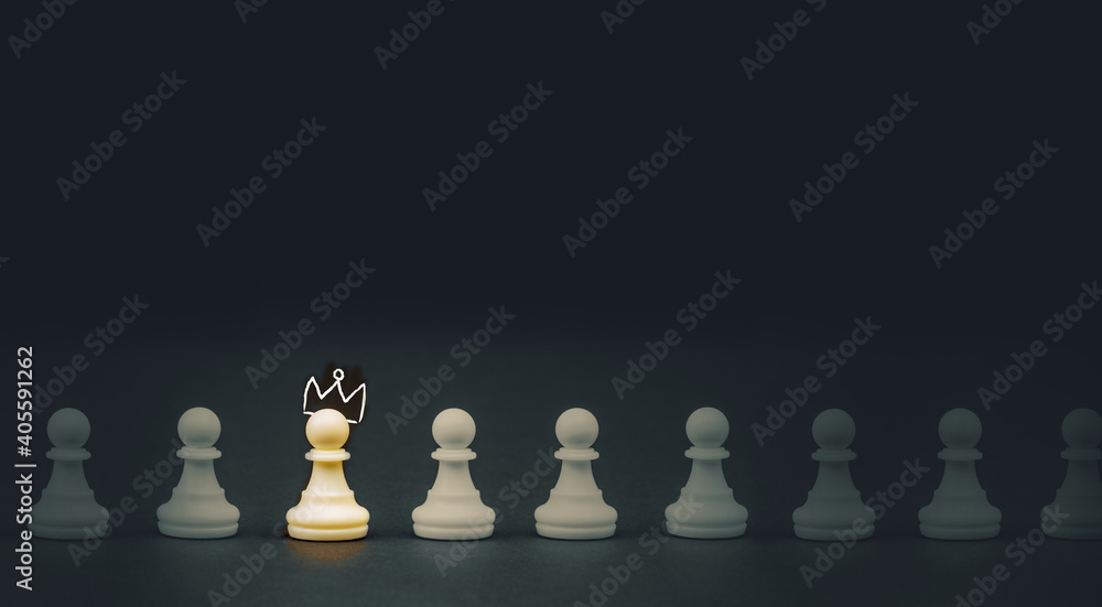 Brain and ideas can make different concept, Chess pawn with crown standing out from the crowd Brain and ideas can make different concept, Chess pawn with crown standing out from the crowd