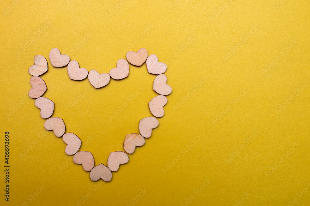 Little wooden hearts on yellow background. Little wooden hearts on yellow background.