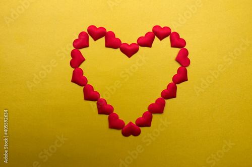 Little red hearts on yellow background.