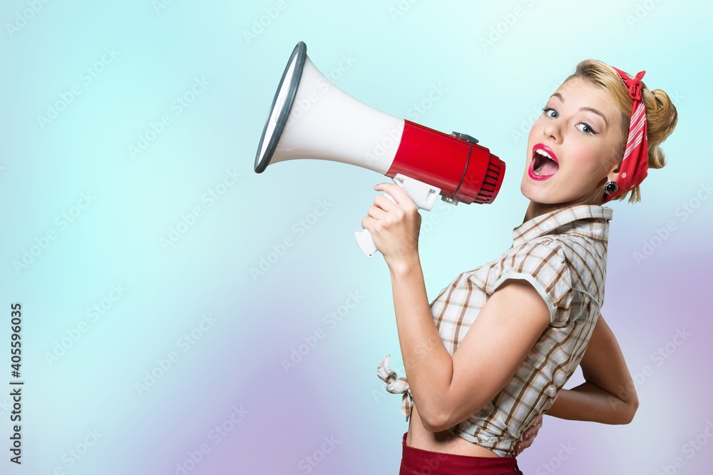 Naklejka premium Beautiful woman holding megaphone and screams