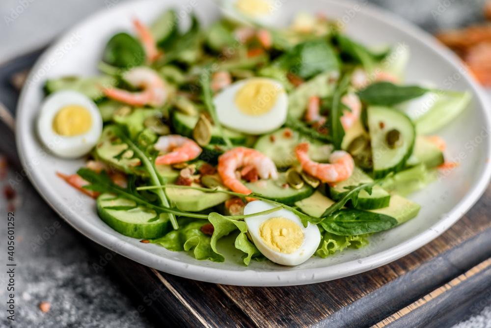 Salad with shrimp, avocado, cucumber, pumpkin seeds and flax seeds with olive oil Salad with shrimp, avocado, cucumber, pumpkin seeds and flax seeds with olive oil