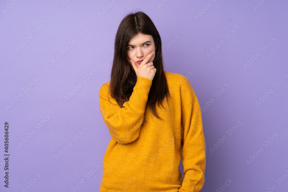 Young Ukrainian teenager girl over isolated purple background having doubts and with confuse face expression Young Ukrainian teenager girl over isolated purple background having doubts and with confuse face expression