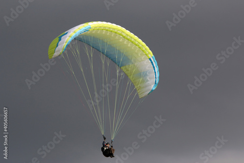 Paraglider flying wing in a cloudy sky	