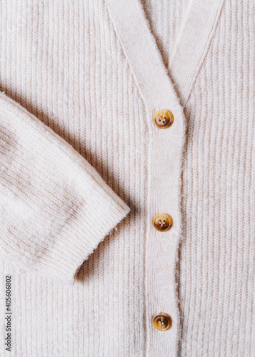close up of a white wool cardigan with buttons
