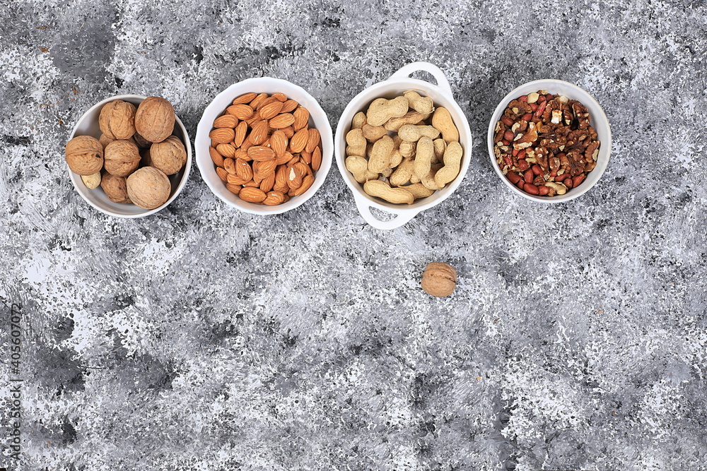 Assortment of different nuts, the concept of healthy natural food, almonds, pecans, pistachios, cashews, walnuts and pine nuts, high-calorie food with vegetable protein, the basis of diet food