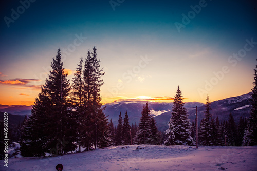 Beautiful dawn in the winter snow-covered mountains and amazingly beautiful clouds © Denis