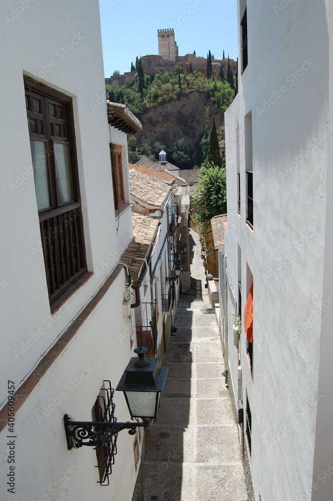View of the streets and old buildings of Granada, historic city of Andalusia (Spain). The Alhambra from the neighborhood of El Albaicin (or Albayzin).
