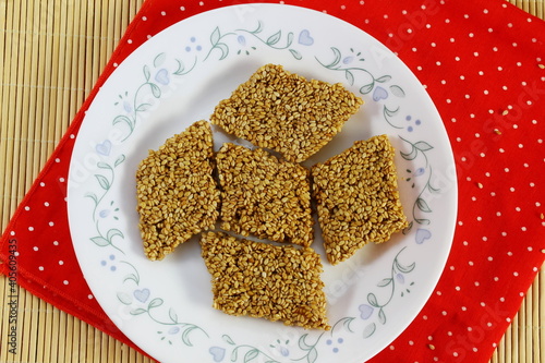 indian traditional homemade festival sweet til chikki made with sesame seed and gud or jaggery photo