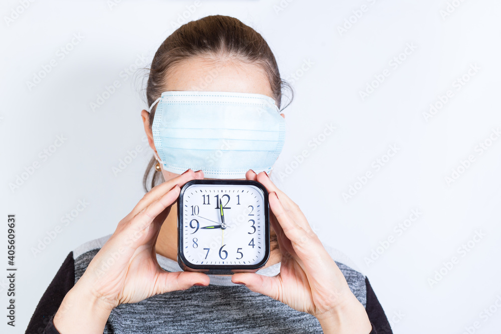 Waiting for lockdown over. People during quarantine. Great quarantine period. Woman in mask with clock. Waiting for lockdown over. People during quarantine. Great quarantine period. Woman in mask with clock.